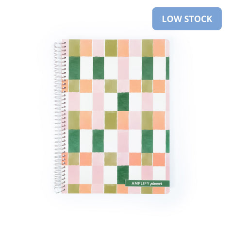 Painted Mosaic Spiral Notebook showcasing a colorful grid pattern on the cover, perfect for organization and creativity.