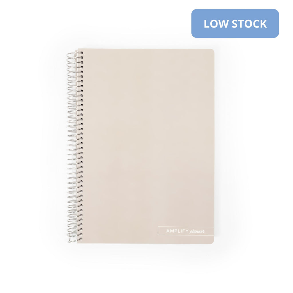 Almond Croissant Spiral Notebook by Amplify Planner with a soft-touch synthetic cover in classic beige, featuring durable metal coil binding and a blank front.