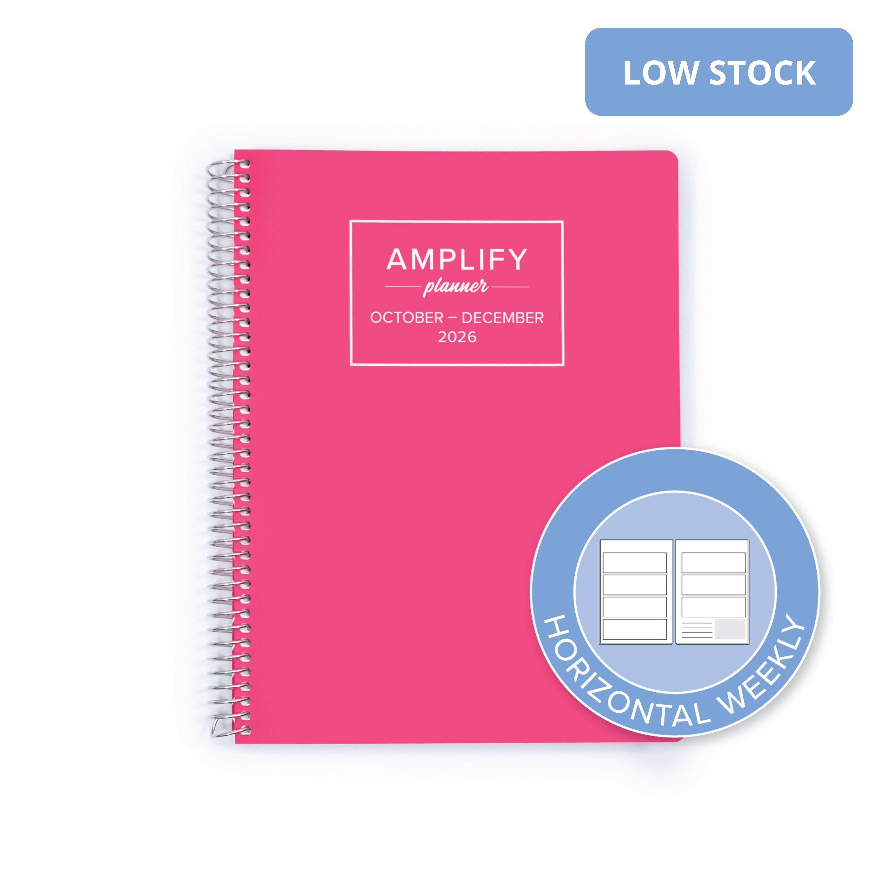 A pink spiral-bound planner shown on a white background, with a blue 'LOW STOCK' badge in the top right and a circular badge in the bottom right reading 'HORIZONTAL WEEKLY'. The planner cover has a white box with the text 'AMPLIFY planner OCTOBER - DECEMBER 2026'.