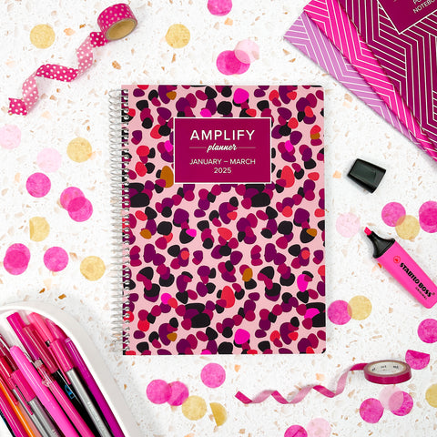 Charisma cover of Amplify Planner Q1 2025 daily planner on a styled background.