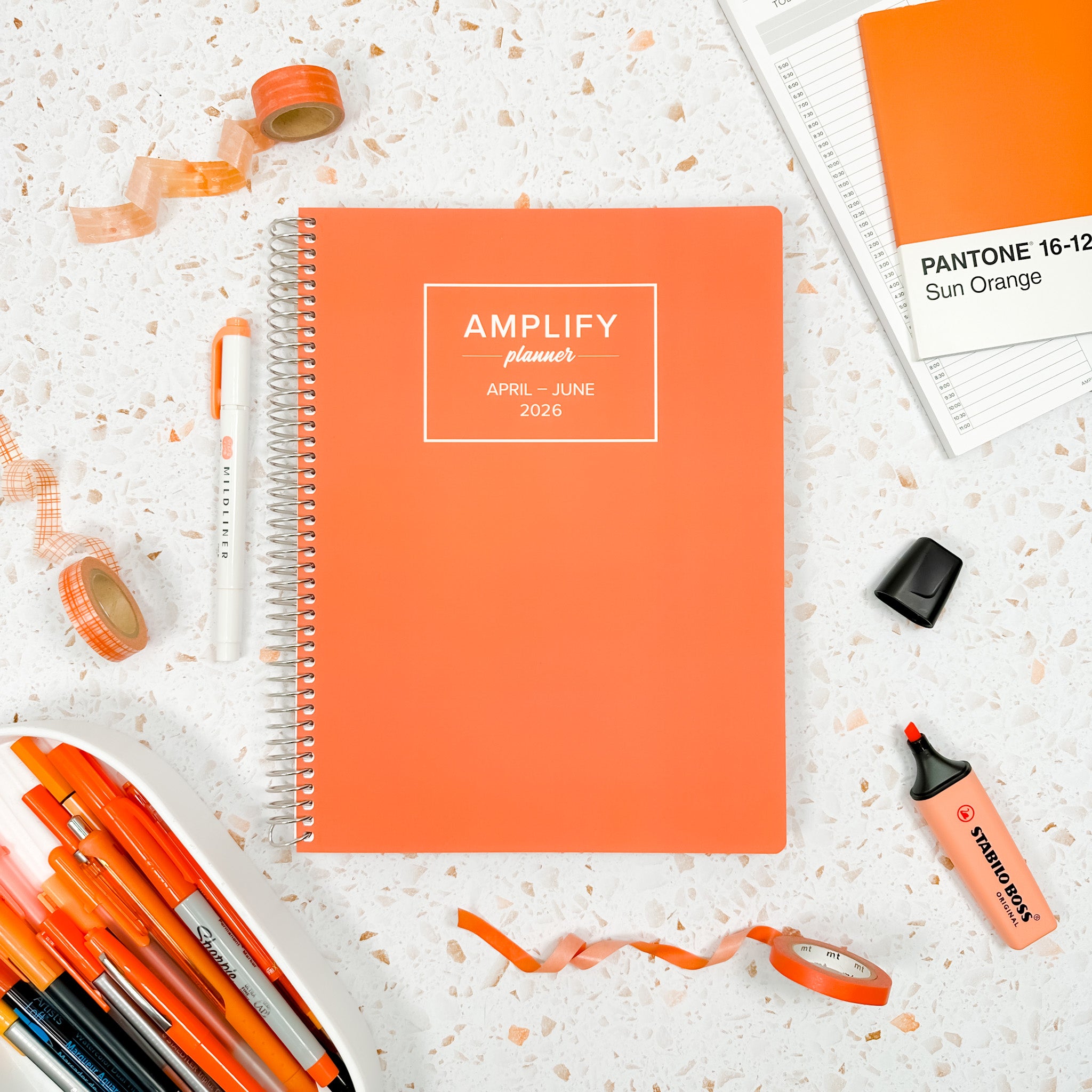 Daily Planner - April-June 2026 - Orange Sherbet displayed with stationery items on a textured background.