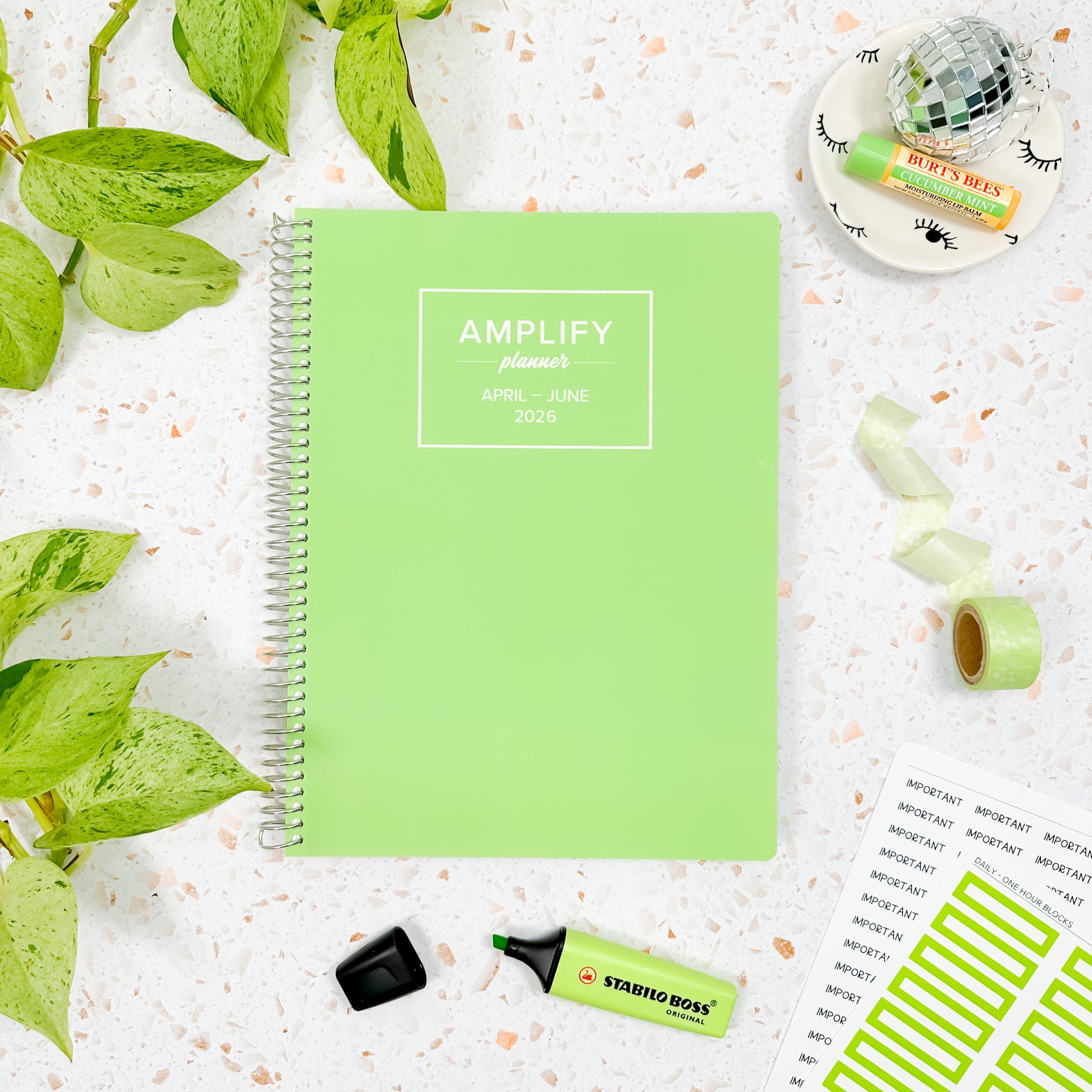 Daily Planner - April-June 2026 - Leaf Me Be displayed with stationery items on a textured background.