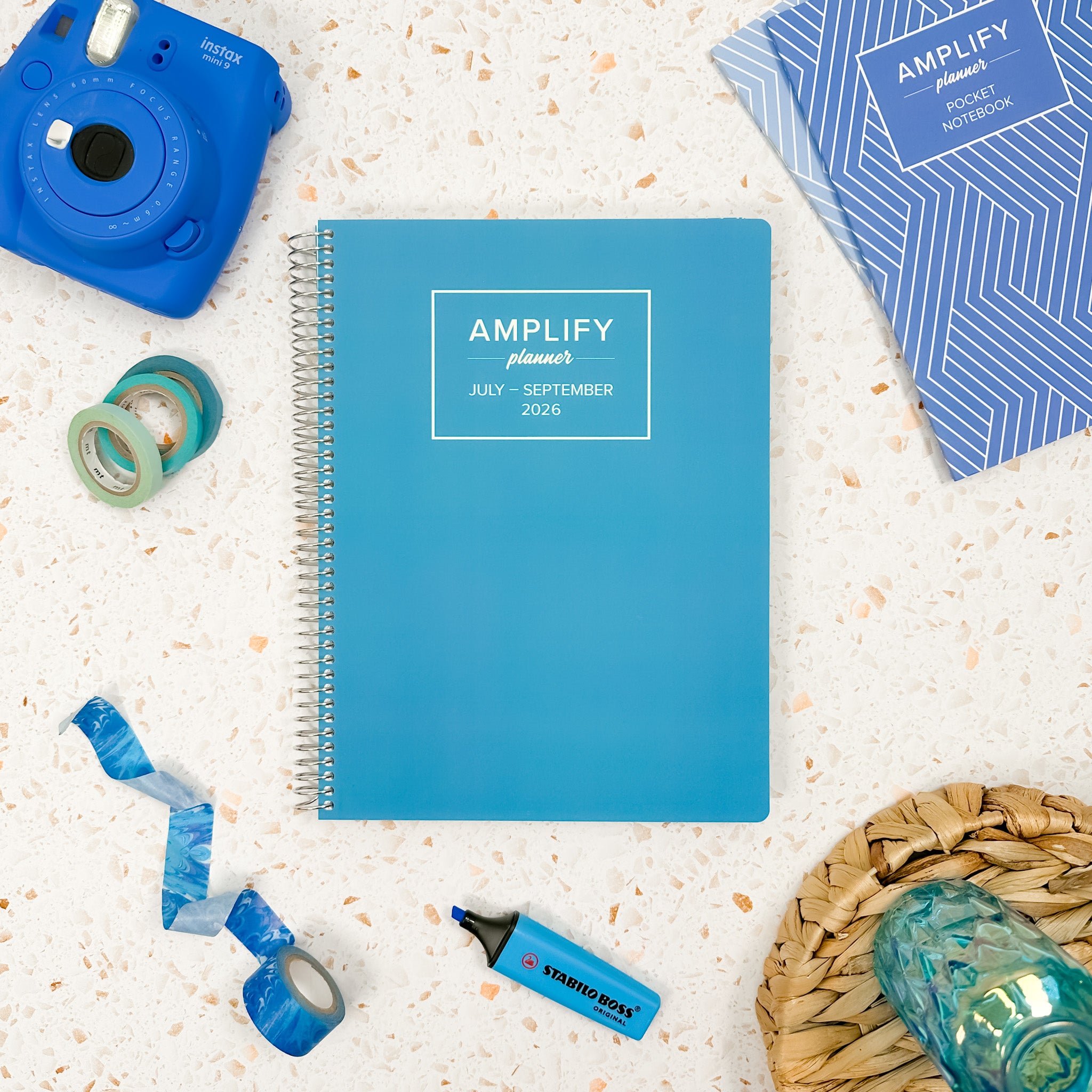 Daily Planner - July-September 2026 shown with creative accessories, highlighting its Poolside Blue cover and organized layout.