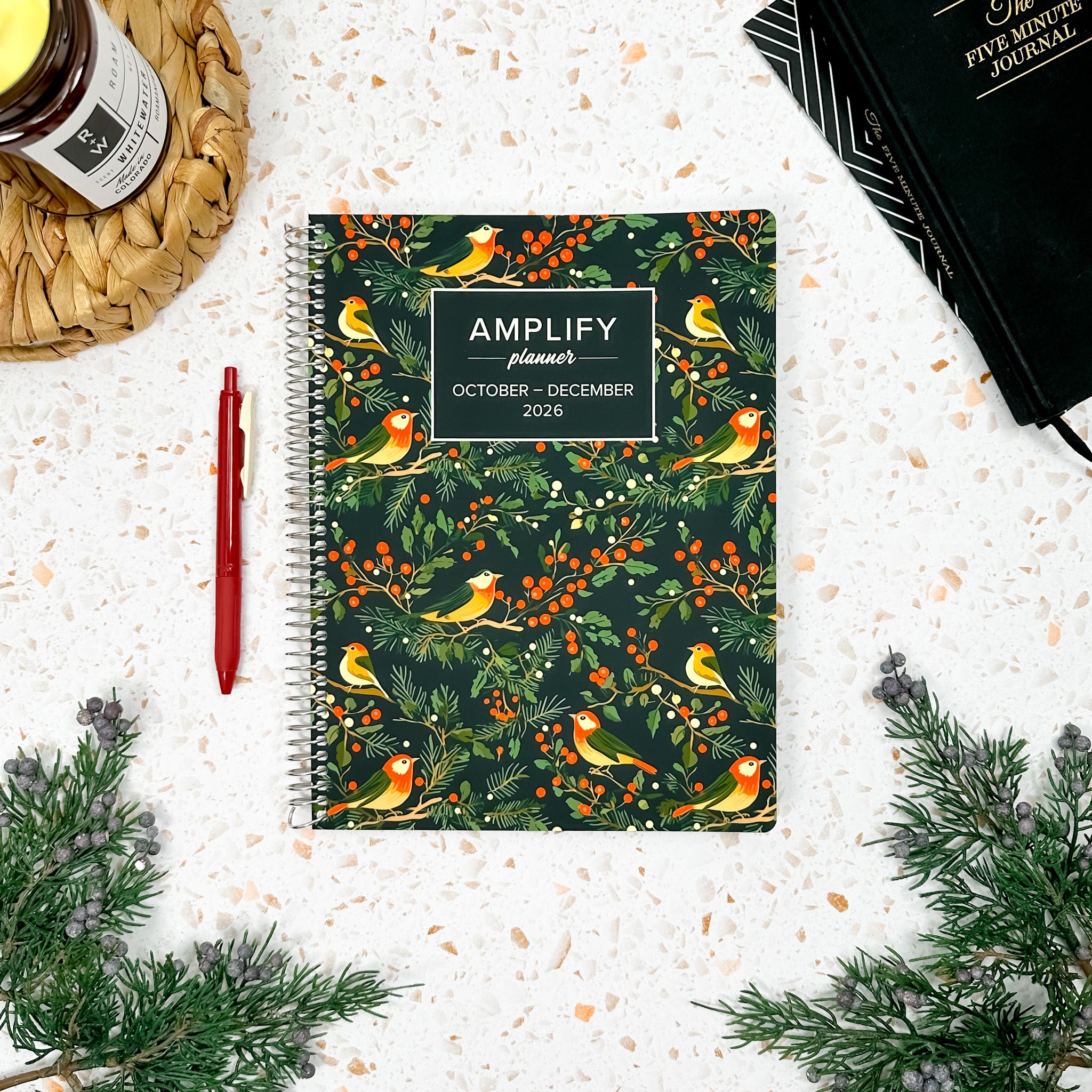 Daily Planner - October-December 2026 - Amplify Planner displayed on a desk with creative tools, showcasing its stylish tan cover.