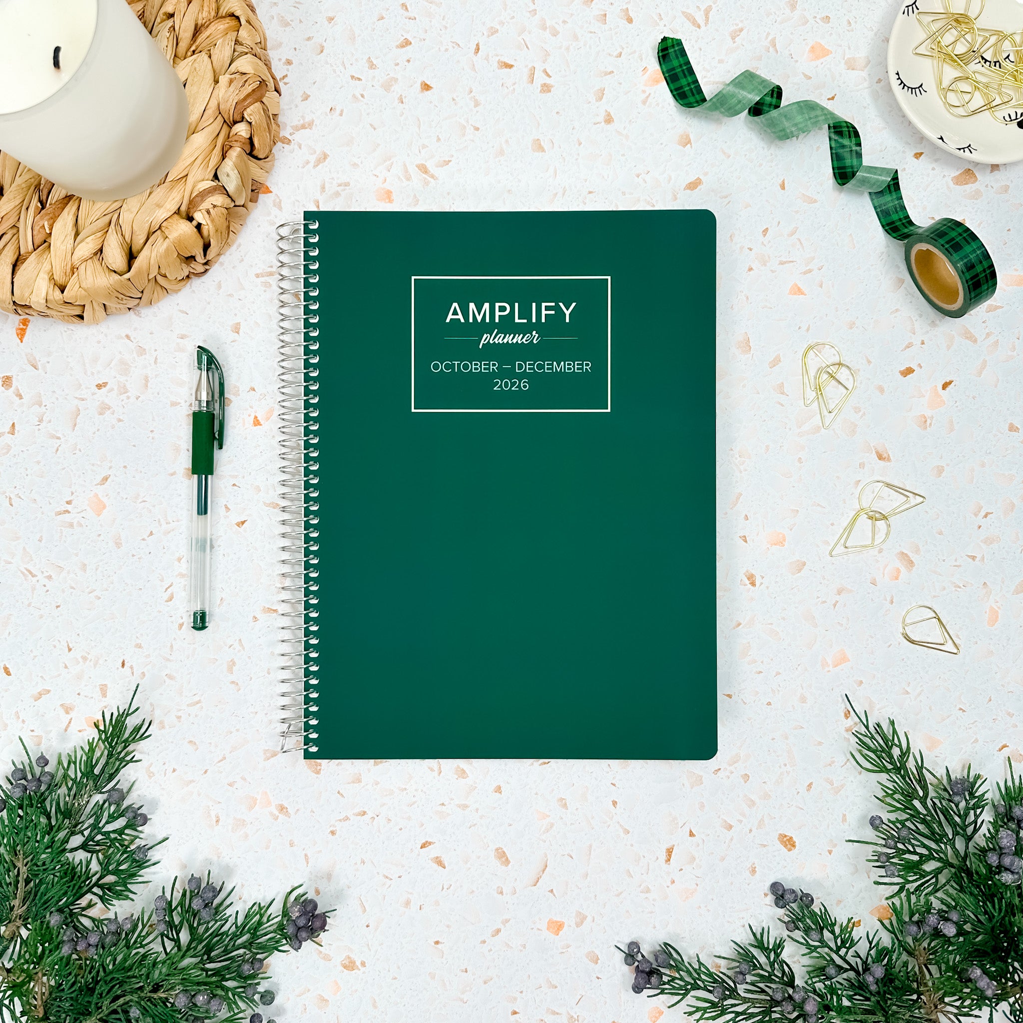 Daily Planner - October-December 2026 - Amplify Planner displayed on a desk with creative tools, showcasing its stylish tan cover.