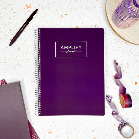 majestic purple cover of undated daily Amplify Planner daily planner on a styled background