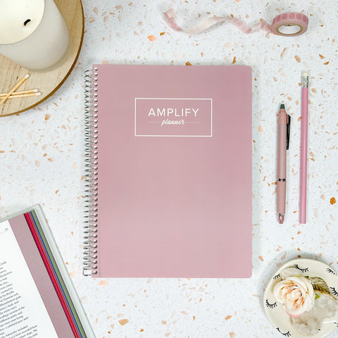 peaceful mauve cover of daily undated Amplify Planner on a styled background