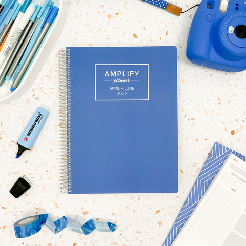 stormy blue 2025 daily amplify planner on styled background