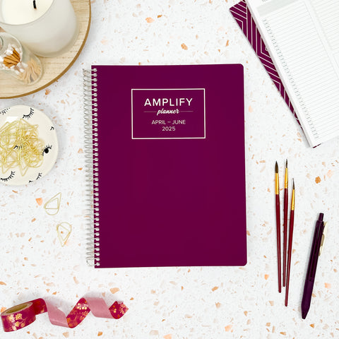 violet bloom 2025 daily amplify planner on styled background