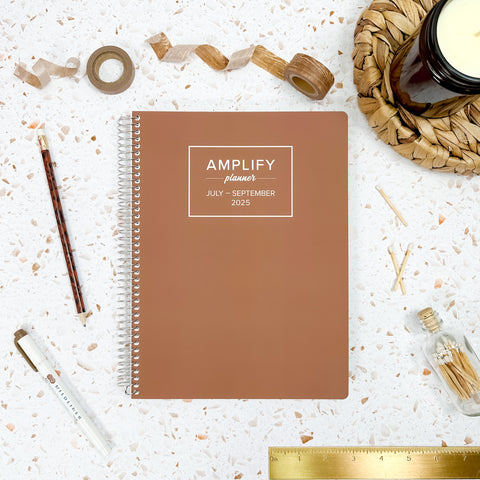 mocha mousse 2025 daily amplify planner on styled background