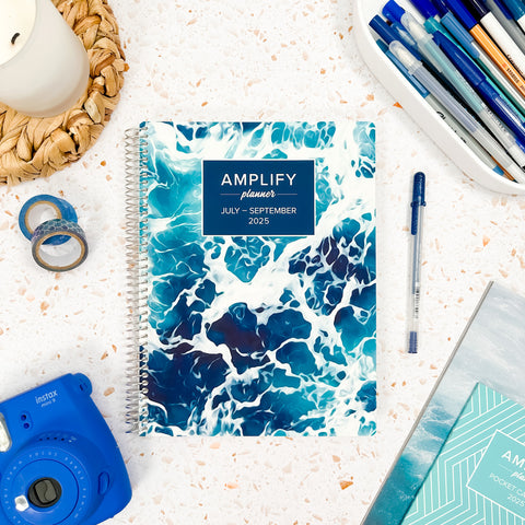 high tide 2025 daily amplify planner on styled background