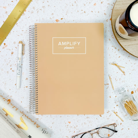 golden light weekly Amplify Planner july 2025-june 2026 Weekly Planner styled with accessories and decor
