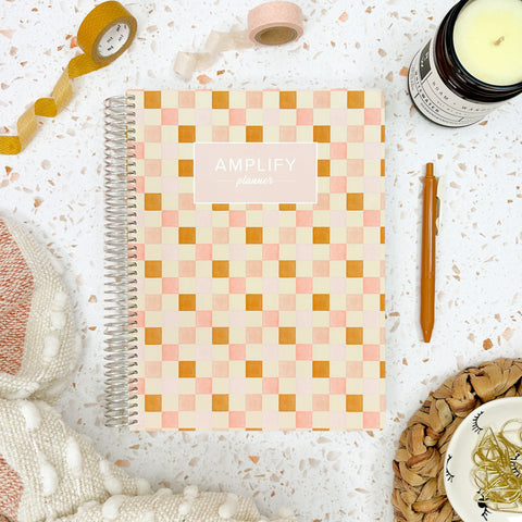check in weekly Amplify Planner july 2025-june 2026 Weekly Planner styled with accessories and decor