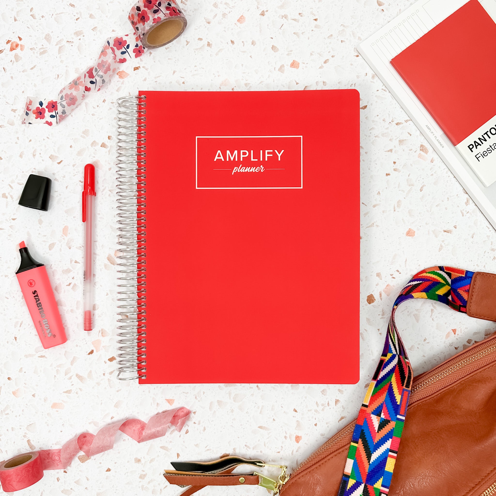 Poppy Red weekly amplify planner on styled background