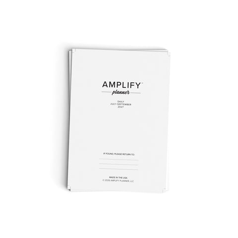 White planner with 'AMPLIFY planner' text on a white background
