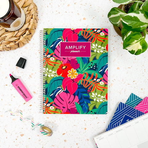 Boldly Tropical cover of undated daily Amplify Planner daily planner on a styled background with decorations