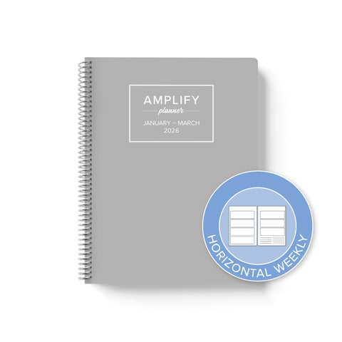 Daily Planner - January-March 2026 showcasing a horizontal weekly layout with a modern grey cover by Amplify Planner, perfect for effective planning.
