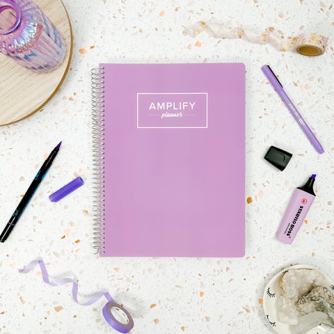 Lavender Grace cover of undated daily Amplify Planner daily planner on a styled background with decorations