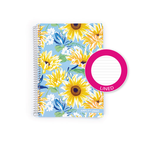 A spiral-bound planner notebook with a light blue background and a floral pattern of yellow sunflowers, white flowers, and blue butterflies, shown with a pink circular 'LINED' sticker overlay on the right.