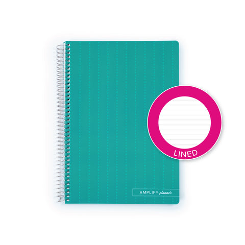 A teal spiral-bound lined notebook with a bright pink circular sticker overlay that reads '-lined'. The notebook has a small white label at the bottom that reads 'AMPLIFY planner'.