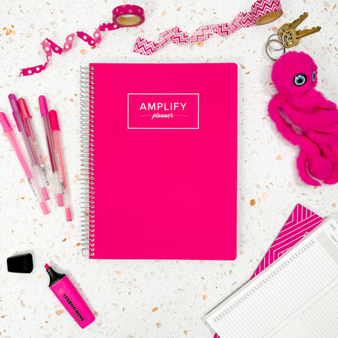 Make Moves Pink cover of undated daily Amplify Planner daily planner on a styled background with decorations