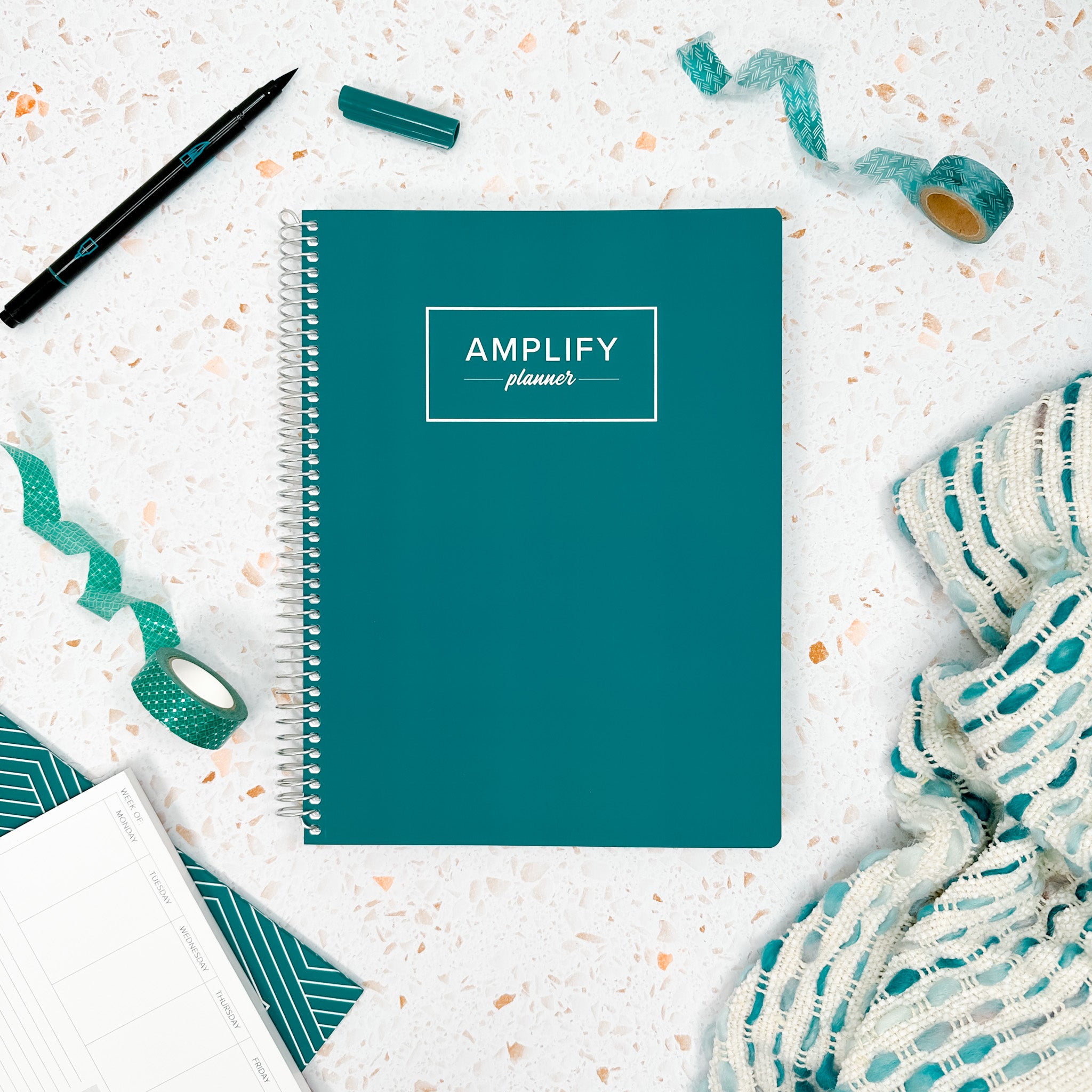 Teal Within cover of undated daily Amplify Planner daily planner on a styled background with decorations