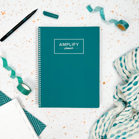 Teal Within cover of undated daily Amplify Planner daily planner on a styled background with decorations