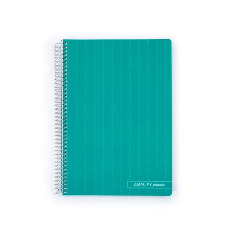 A teal grid-bound notebook with a silver spiral binding and a small white 'AMPLIFY planner' label in the bottom right corner, shown on a plain white background.